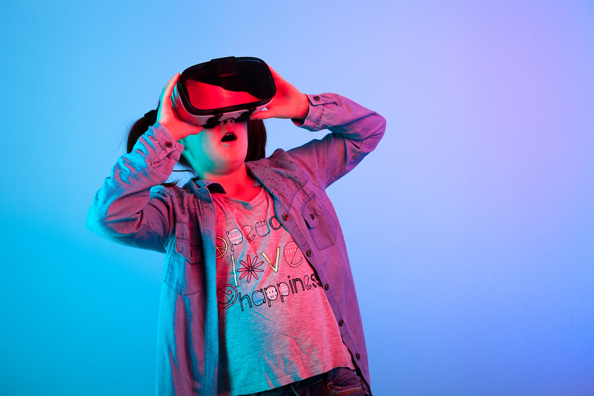Young girl watching a movie on VR headset